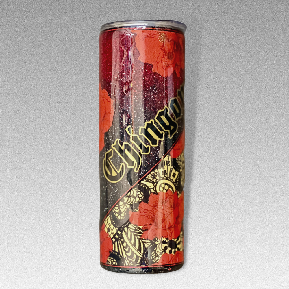 20oz tumbler showing the front of the tumbler. It has a diagonal cut of vinyl, the vinyl has a dark gold background over lapped with black lace and red roses blooming with gold centers. The other quarter part has an ombre design with black and deep reads. The word "CHINGONA" is placed diagonal over the glitter.