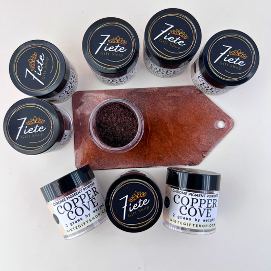 Top-down photo of Siete Gift Shop Copper Cove chrome pigment powder jars surrounding an open container of deep metallic copper pigment on a copper-colored sample card.