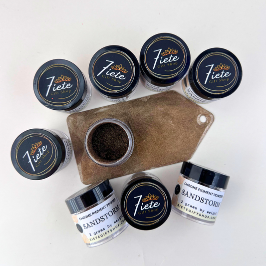 Jars of Sandstorm chrome pigment powder from Siete Gift Shop displayed beside a brown metallic pigment swatch sample.