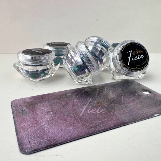 Banarasi chameleon pastel pigment powder jars from Siete Gift Shop showing a soft teal, lavender, and blue color-shifting shimmer with a finished sample swatch in front.