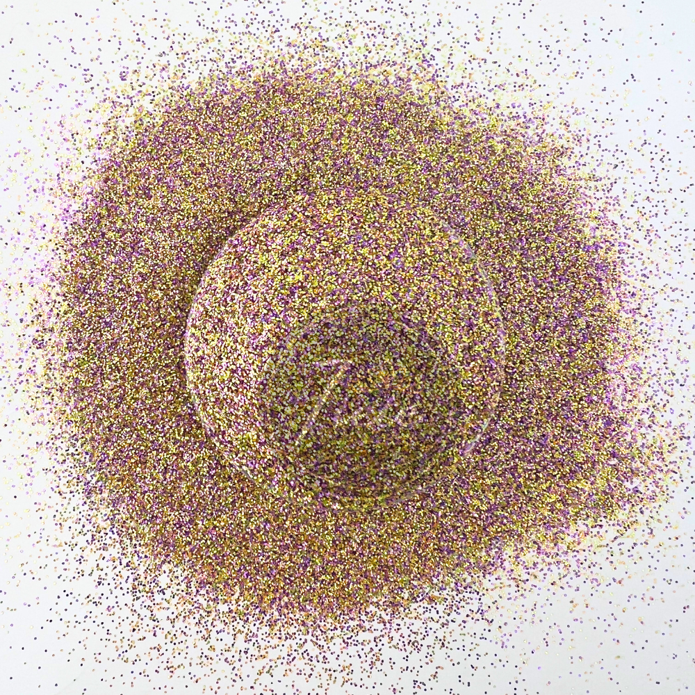 Close-up image of a custom glitter mix featuring shimmering purple, gold, and iridescent pieces scattered around a clear container, showcasing its high sparkle and colorful blend.