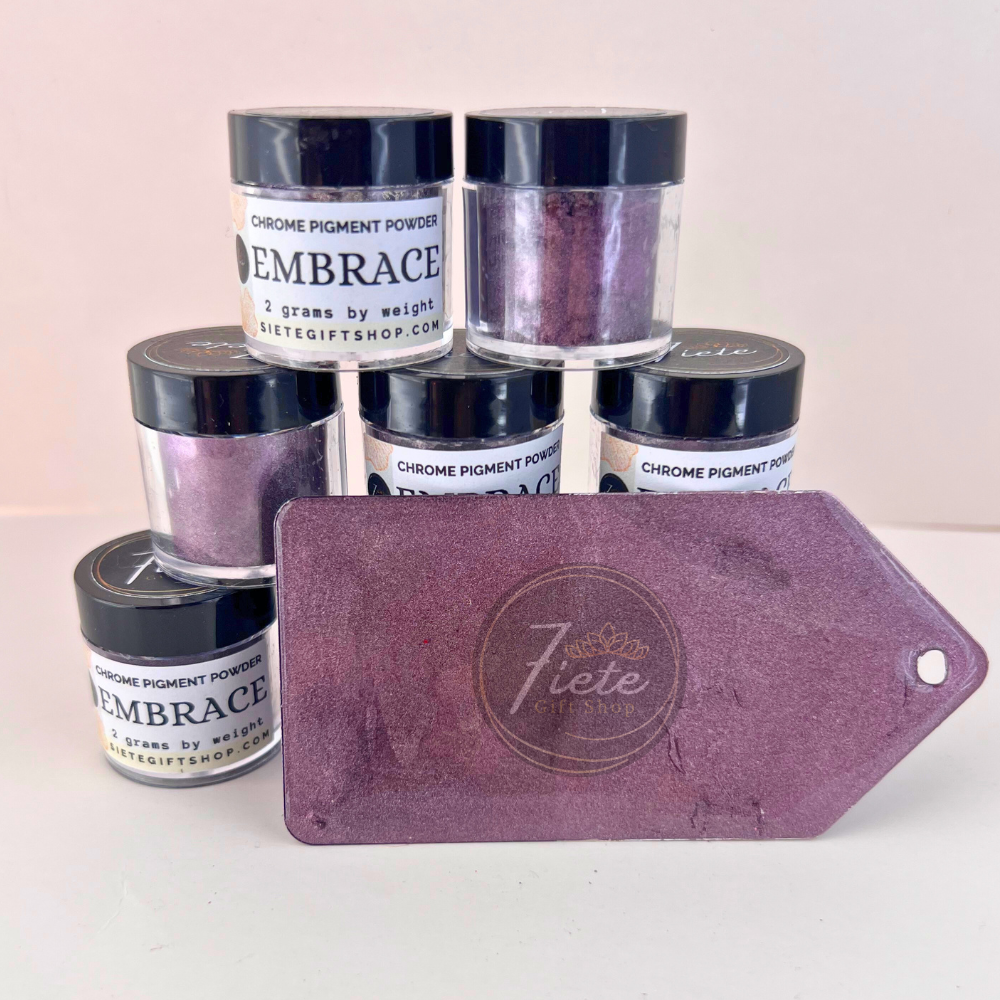 Embrace chrome pigment powder in a 2g jar from Siete Gift Shop, shown with a deep plum-purple metallic swatch and stacked pigment containers.