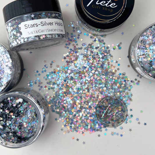 Silver holographic star-shaped glitter scattered on a light surface with rainbow reflective shine, Star – Silver Holographic Glitter by Siete Gift Shop