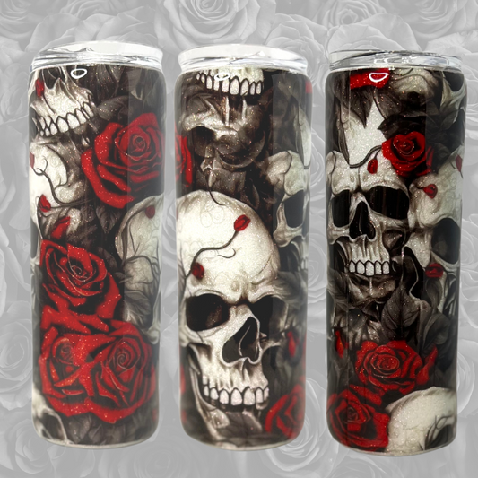 20oz tumbler, showing three sides of the tumbler to reveil the images around the cup.  Multiple skulls stacked over the other, surround by red and black roses.  The back is white glitter so it's visible through the white skulls.