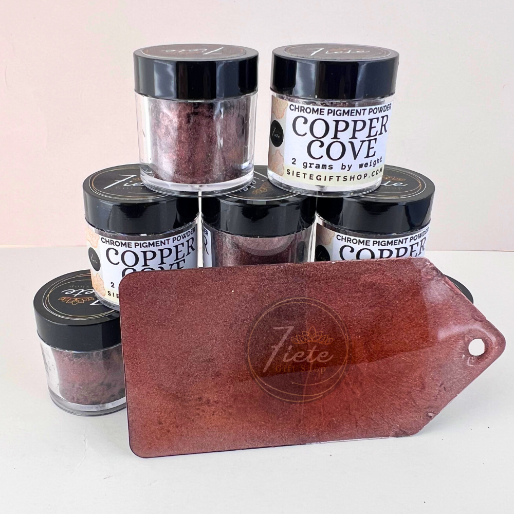 Top-down photo of Siete Gift Shop Copper Cove chrome pigment powder jars surrounding an open container of deep metallic copper pigment on a copper-colored sample card.