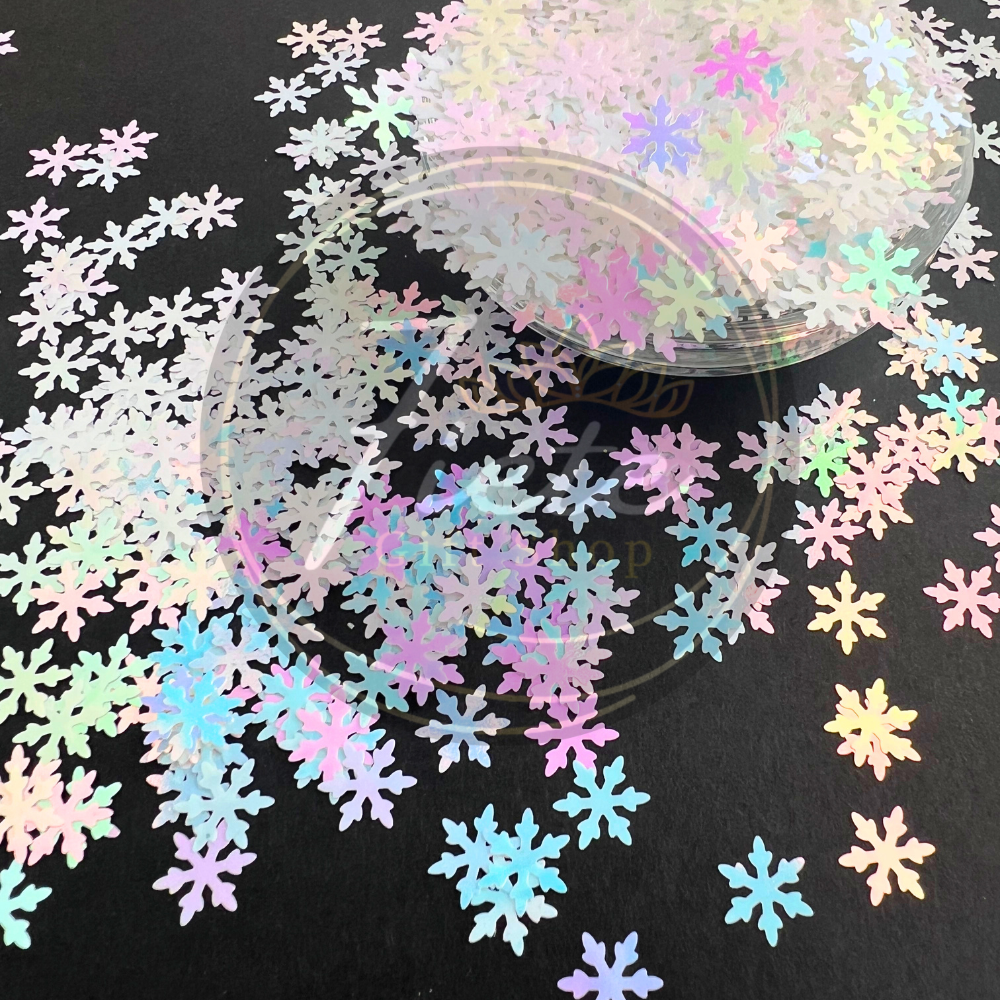 Holographic snowflake confetti on a black background