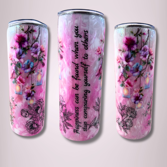 20oz skinny tumbler with pink marbled background, floral designs, glitter accents, glow-in-the-dark pigments, and inspirational quote about happiness and self-comparison.