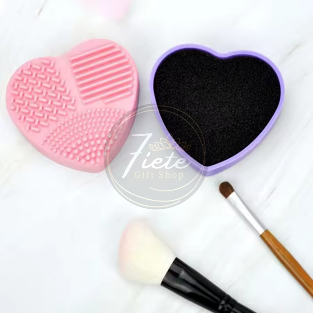 Brush Buddy heart-shaped silicone brush cleaning tool with textured scrubber and sponge insert, used to clean glitter and pigment brushes for crafting and tumbler making.